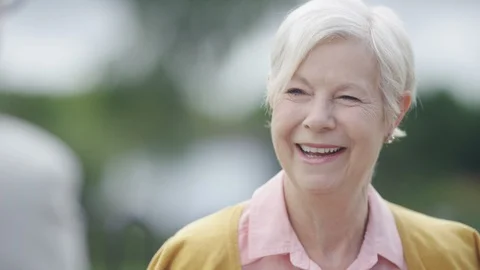 Senior lady laughs during a conversation Stock Footage 91513610