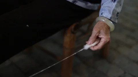 Senior Lady. Sat down spinning wool Stock Footage 97621335