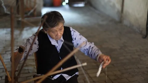 Senior Lady. Sat down spinning wool Stock Footage 97621585