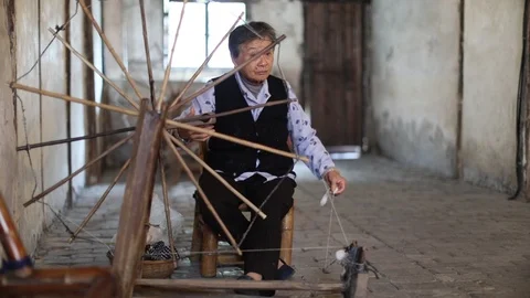 Senior Lady. Sat down spinning wool Stock Footage 97622468