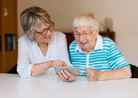 Senior lady using smart phone with her mother Stock Photos