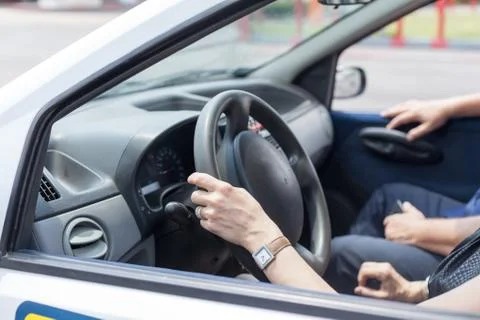 Senior learning to drive a car with a driving instructor Stock Photos