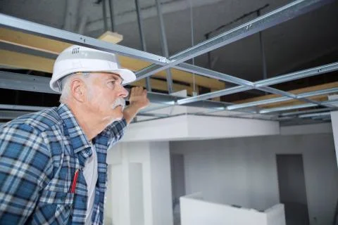 Senior male checking ceiling Stock Photos