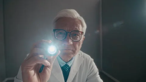 Senior Male Doctor Using Flashlight during Patinet Examination Stock Footage 336666511