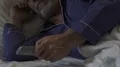 Senior male lying at night unable to sleep, switching TV channels with remote HD Footage