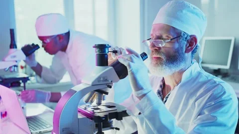 Senior male scientist using microscope in laboratory Video stock 304891593