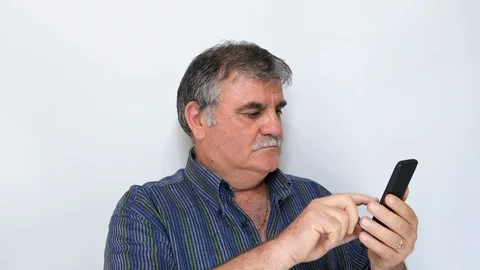 Senior man (50s-60s) browsing smartphone isolated on white background Stock Footage 115447903