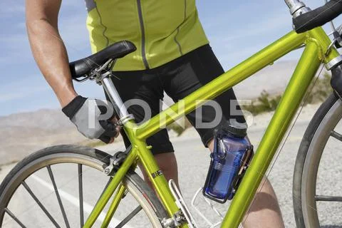 Senior Man Adjusting Bicycle Seat Stock Photos