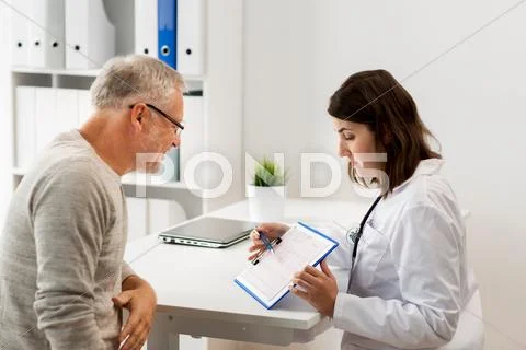 Senior man and doctor meeting at hospital Stock Photos