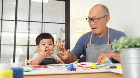 Senior man and little child boy in apron painting art Stock Footage 262024966