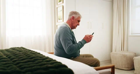 Senior, man and scroll in bedroom with phone, research and browsing website for Stock Footage 339135124