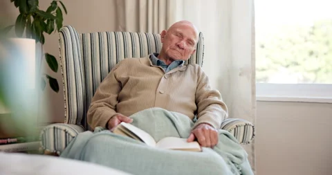 Senior, man and sleeping with book in retirement home for snooze, nap or rest on Stock Footage 340637060