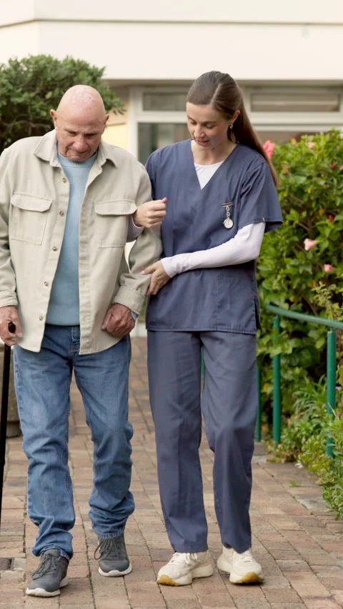 Senior, man and walking stick with nurse in outdoor garden for mobility Stock Footage 340908128