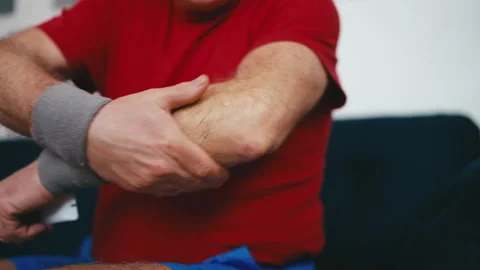Senior man applying cream ointment on his elbow for pain relief, arthritis Stock Footage 247977238
