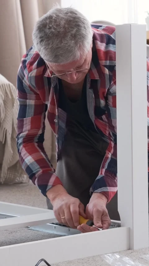 Senior Man Assembling Or Repairing Table With Screwdriver At Home Video stock 305544681