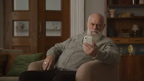 Senior Man with Bad Eyesight Using Smartphone Video stock 245486028