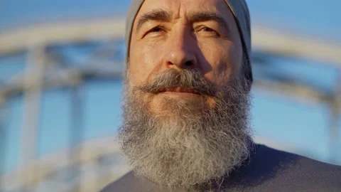 Senior man with beard looking at camera Stock Footage 135563818