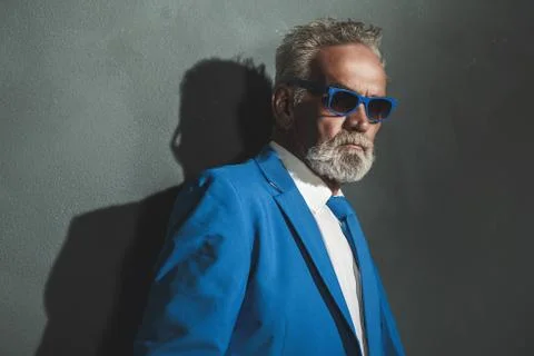 Senior Man in Blue Elegant Fashion Against Wall Stock Photos