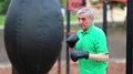 Senior man boxing with a punching bag HD Footage