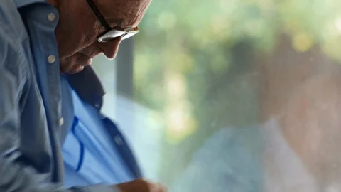 Senior man buttoning a blue shirt. 스톡 동영상 88374167