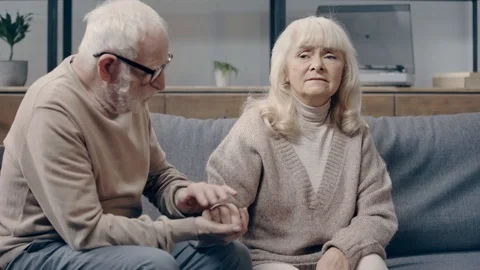 Senior man calming down upset wife with dementia Stock Footage 119971047