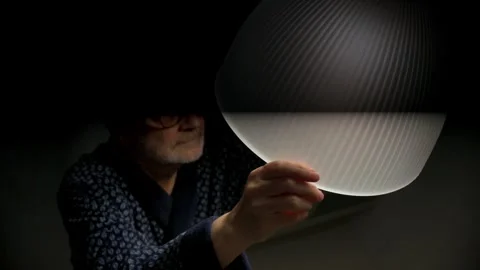 Senior man changing light bulb at home during daily routine chore task Stock Footage 329906311