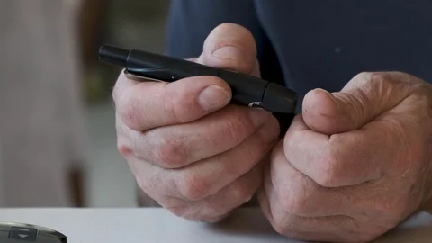 Senior Man Checking Blood Sugar Level At Home with glucometer Stock Footage 120326470