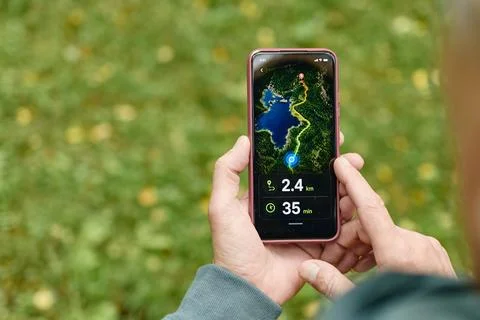 Senior Man Checking Hiking Navigation Map on Smartphone Outdoors Stock Photos