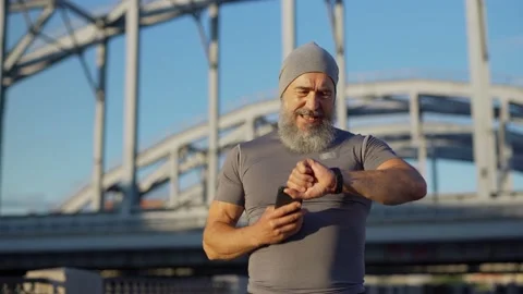 Senior man checking race time after running 스톡 동영상 135563186