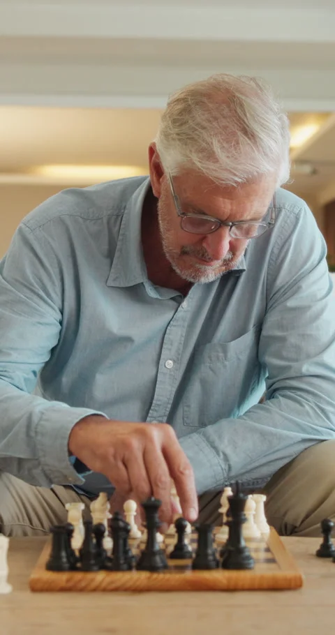 Senior man, chess and game in home with strategy, solution or problem solving in Stock Footage 335912040