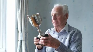Senior man cleaning his trophy Stock-Footage 85514575
