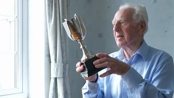Senior man cleaning his trophy Video stock 85516625