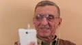 Senior man communicates through a smartphone. Man with mobile phone HD Footage
