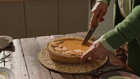 Senior Man Cutting Delicious Pumpkin Pie for Thanksgiving Dinner Stock Footage 341396276