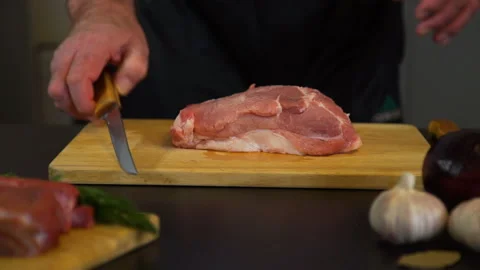 Senior Man Cutting Meat on a Cutting Board Stock Footage 102496649
