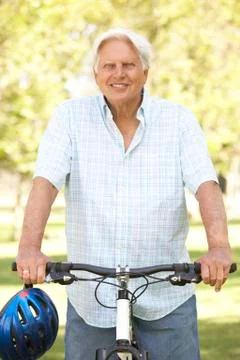Senior man on cycle ride in park Stock Photos