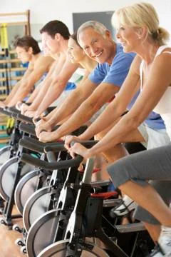 Senior Man Cycling In Spinning Class In Gym Stock Photos