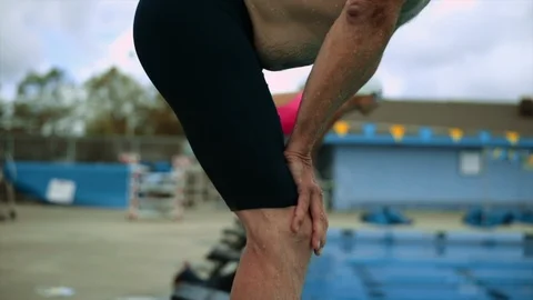 Senior man on a diving block. Stockbeeldmateriaal 88405324