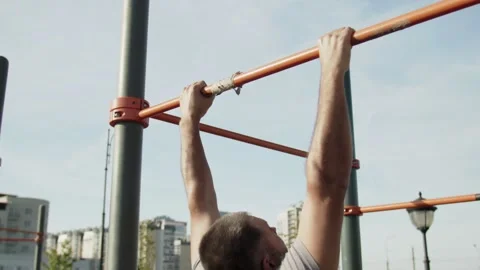 Senior man doing pull ups on horizontal workout outdoors Stock Footage 143505886