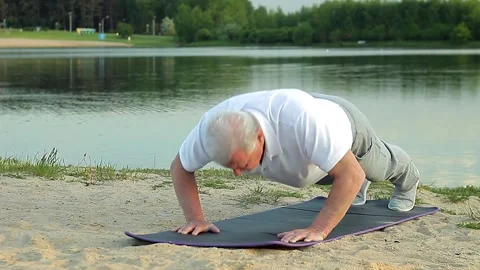 Senior man doing a workout on the river bank. Stock Footage 168537432