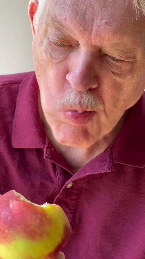 Senior man eats crisp apple Stock Footage 219160195