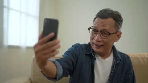 Senior man enjoy using smartphone on video call, happy retirement man make call. Stock Footage 265407275