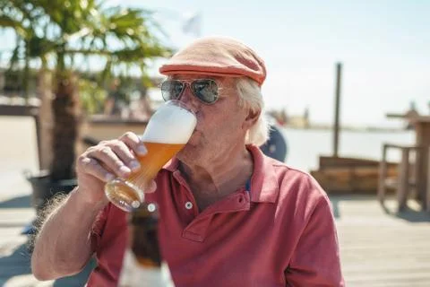 Senior man enjoying an ice cold beer Stock Photos