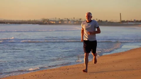Senior Man Exercising At The  Beach Stock-Footage 159768748