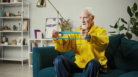 Senior man exercising hands with elastic band, old sportsman doing sport in Stock Footage 166422931