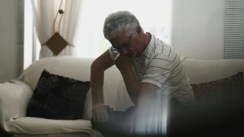 Senior Man Experiencing Frustration and Preoccupation, Alone at Home in Can.. Stock Photos