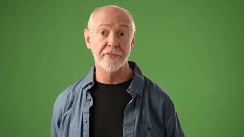 Senior Man Expressing Emotions in Front of Solid Green Screen Background Stock Footage 305570823