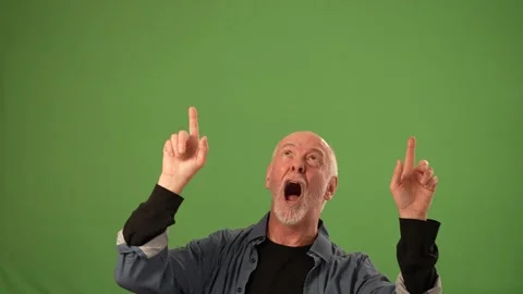 Senior Man Expressing Excitement With Hands Raised in Front of Green Screen Stock Footage 305522975