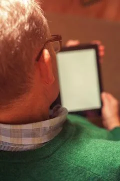 Senior man in eyeglasses using digital tablet Stock Photos
