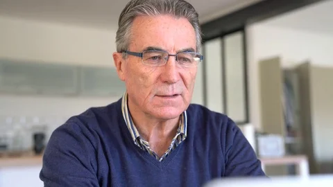 Senior man with eyeglasses using laptop computer Stock Footage 72137646